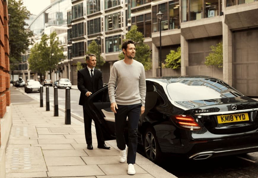 a man walking towards a car